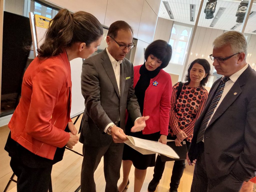 Steve Pwdborski showing document to ministers