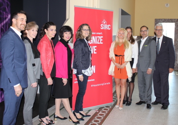 Government and sport leaders in front of SIRC banner