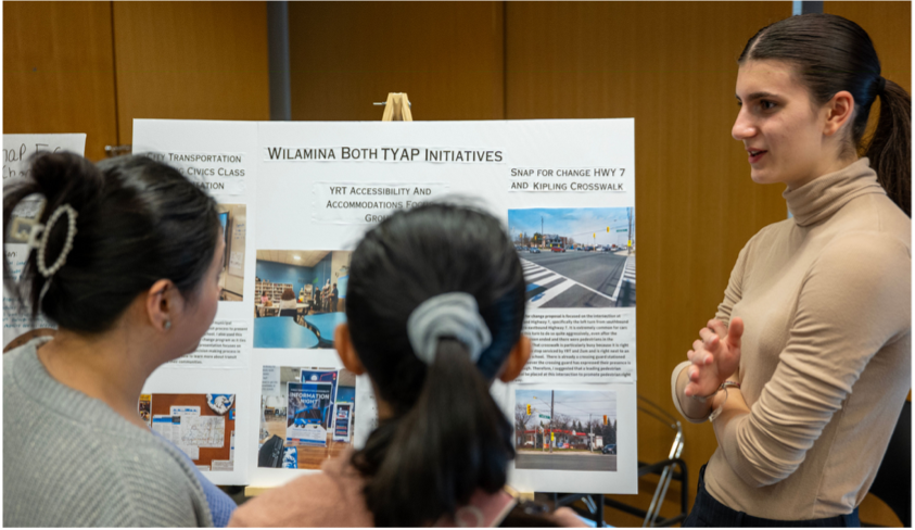 Photo of people looking at a project poster