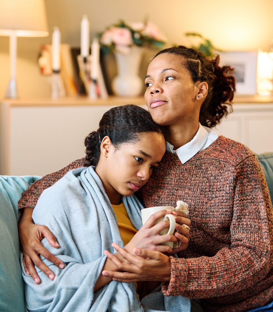 Sick teenager black girl with flu and worried mother